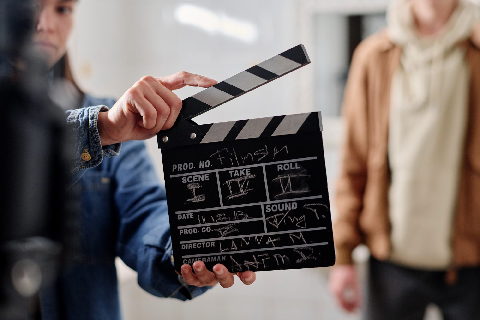 Filmmaking Scene with Film Clapper and Crew Members Filmmaking Scene with Film Clapper and Crew Members