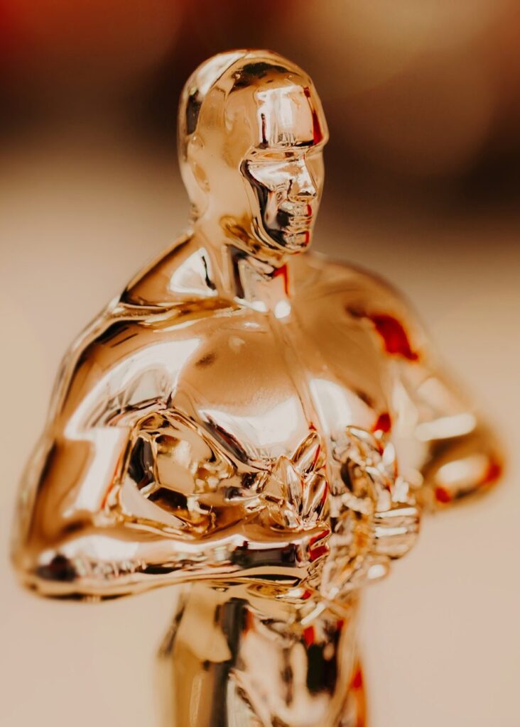 Nomination and Oscar reward concept. Golden statue for victory and success